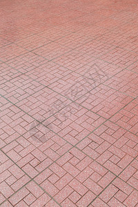 红砖在人行道背景上铺石头地板草质图片