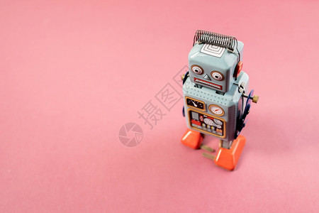 老的蓝色粉红背景老式机器人锡玩具经典的图片