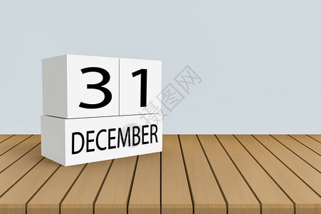 假期倒数12月3日木制面板桌上的白色立方体刻度复制空间灰壁背景季节图片