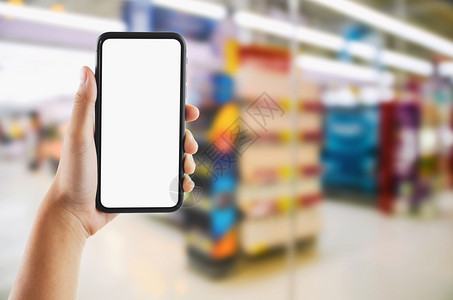 小样亚洲在超市商店上手持移动白屏幕的手持色背景模糊电话图片