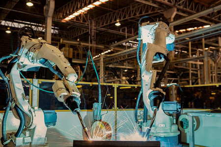 行业重的工机器人是汽车装配厂新程序的试运行在汽车装配厂未来派图片