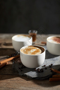 木制桌上的热咖啡杯和豆浓芳香热的图片