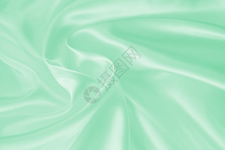 平滑优雅的绿色丝绸或纹质可用作背景抽象的涟漪布料图片