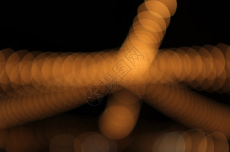 Goldenbokeh抽象光橙色背景概念爱夏天辉光发的美丽图片