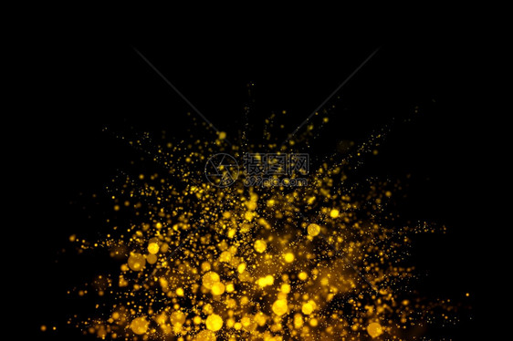 金色闪光和抽象烁在黑暗背景上闪发光的亮粉尘颗粒黑暗的优质辉光图片