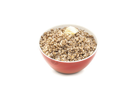 营养丰富分美味的红陶瓷碗中干热小麦其中一块黄油在白色背景上孤立红瓷碗中的干热小麦其中一块是白的碎奶粉图片