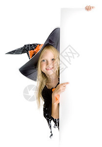 垂直的指点美丽笑着微小女孩长金发在服装指着标志黑帽与网蜘蛛和橙色弓空间眼睛图片