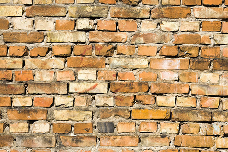 城市的建成旧砖墙结构粗硬的旧砖墙大量损坏背景一部分由用粘土砖墙制成的块组建筑肮脏图片