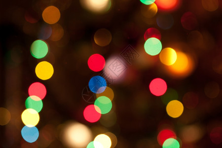 辉光散景派对闪耀明亮的彩色圣诞光灯抽象背景图片