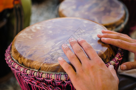 音乐家白色的男人在户外玩djembe非洲鼓手指图片