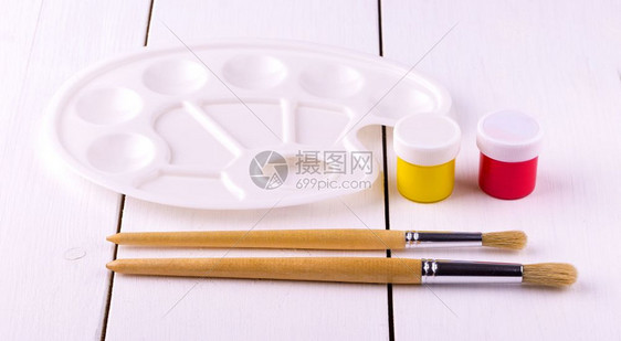 艺术家丙烯酸纤维创造力设置用于绘制笔刷白色木桌子上的调色板图片
