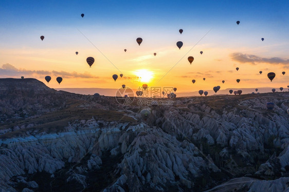 公园结石旅游热气球和土耳其卡帕多西亚戈雷梅日出时红谷图片
