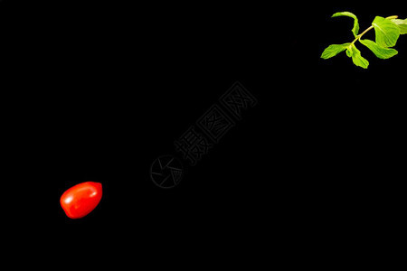 高架农业单樱桃番茄一面的顶端视图和薄荷叶在黑色背景最小图像样式上与对角截然相反并带有文本复制空间极简主义者图片