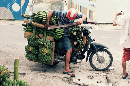 重的转移商业越南男子每天乘摩托车在胡志明市运送许多香蕉是越南流行的农产品注iBARBAR图片