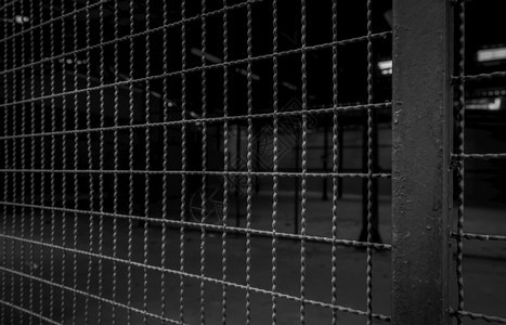 光栅私人地区黑暗背景钢围栏安全墙仓库建筑内门网状围墙自由概念障碍铁栅和电杆的链条铁栅栏和电线杆的链条倒钩工业图片
