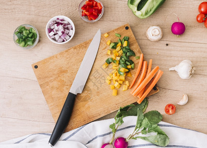 牛腩切碎用刀子蔬菜木桌用刀子切开板水平的图片