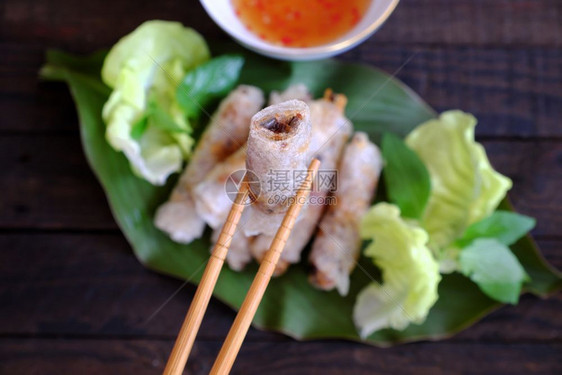 炒吃春卷糕饼或烤焦饭是越南菜食中流行的物由肉和包装纸用米塞成然后深炸吃沙拉和鱼酱最佳内姆图片