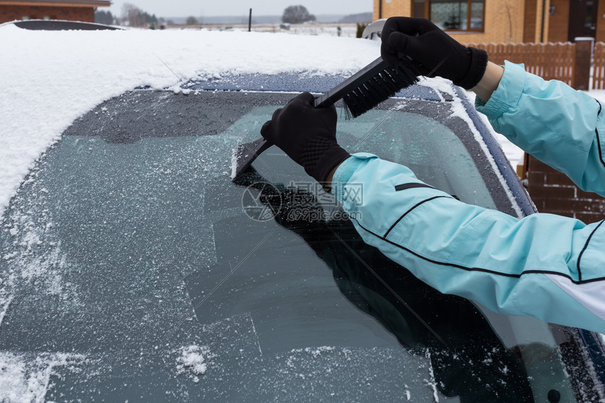 成人细节女在冬天从车里打扫雪场景图片