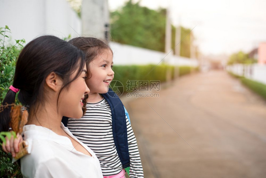 头发父母妈和女儿在从学校爱与日托概念回家后一起微笑快乐家庭与甜蜜主题HippyFamilyandHomesweethome婴儿图片