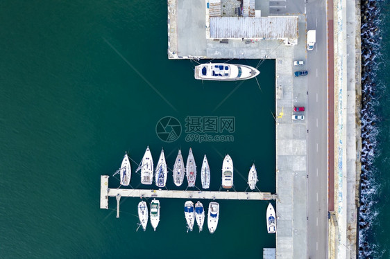 白色的经过游艇和小型机动船只的无人驾驶飞机在港口游艇和帆船的顶端景点都停泊在码头上車處图片