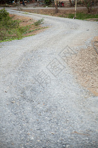 缠绕风景优美路是一条填满了岩石和黄麻的公路园景图片