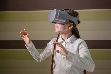 戴虚拟现实耳机的女孩通过视频和游戏探索虚拟现实世界未来技术女孩通过视频和游戏探索虚拟现实世界增强型孩子风镜图片