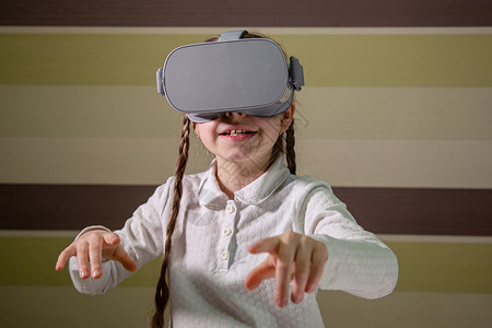 风镜戴虚拟现实耳机的女孩通过视频和游戏探索虚拟现实世界未来技术戴虚拟现实耳机的女孩通过视频和游戏探索虚拟现实世界桌子创新图片