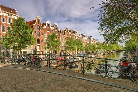 每天在阿姆斯特丹的典型建筑运河和自行车在荷兰阿姆斯特丹的荷兰典型建筑运河和自行车传统桥著名的图片