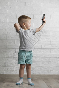 使用电话模拟小男孩子时尚数字的图片