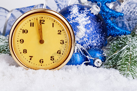 圣诞节冷杉蓝色的古老钟表和圣诞球放在本底霜冻冷的Fir树上圣诞装饰品图片
