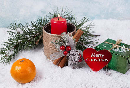作品喜庆的十二月红蜡烛礼品盒橘子和雪地背景的圆木枝印有贺卡图片