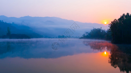 日出时帕康湖的风景温柔晨雾覆盖了湖和山上的背景在越南DienBienPhu的旅行目地对湖注意松树天空反射图片