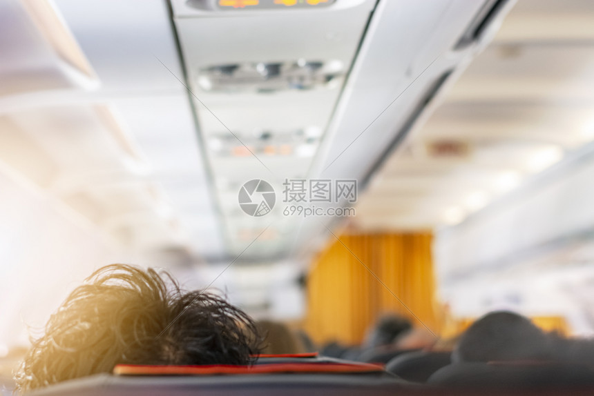 排航班一架飞机的内走廊飞机头顶有黑发厚的乘客口旅行和交通方式的概念旅行和运输方式概念椅子图片