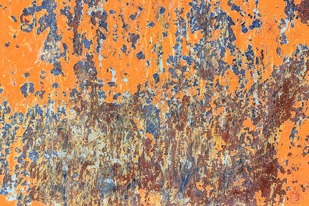 去角质垃圾摇滚粗糙的橙色金属背景有破碎的剥皮涂料和生锈点图片