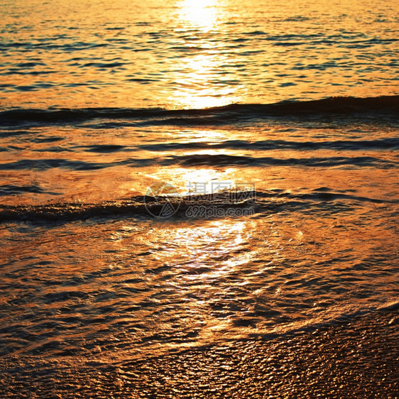日落时沙滩海面的背景图片