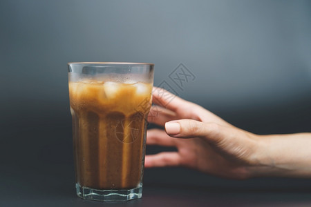 保持咖啡因与冰在深底高杯中手持冰咖啡早晨图片