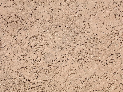 洞中风Beige深黑墙壁纹理背面景松散墙上的沙粉石膏沙子的松散纹理滴图片