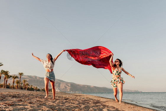 两个在沙滩上奔跑的女子图片