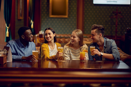 四个快乐的朋友在酒吧柜台喝一群人在吧放松夜间生活方式友谊动庆祝四个朋友在酒吧的柜台喝乐趣夜店享受图片