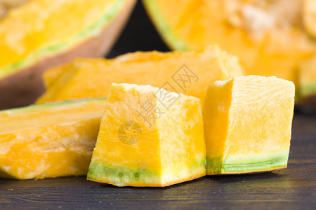 厨房桌上切片和开的橘子南瓜为食物准备的蔬菜或提供切片和开的橙子南瓜立方体季节内脏图片