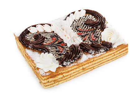 装甲的海绵蛋糕上面装饰着白底孤立的奶油花白色馅饼图片