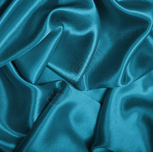 平滑优雅的蓝色丝绸可用作背景投标折痕颜色图片