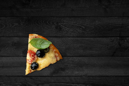 近距离观看披萨在黑木桌上隔离着熔化的芝士地中海可口胡椒图片