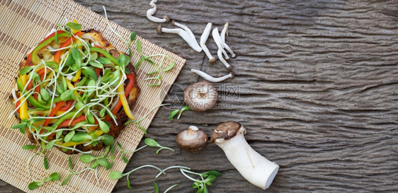 蔬菜土制素食披萨日葵花芽和木桌底蘑菇自制一种图片