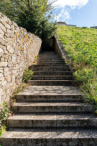 落下秋天爬在公园的花岗岩石楼梯上台阶长到隧道挑战概念或攀登成功的地道图片
