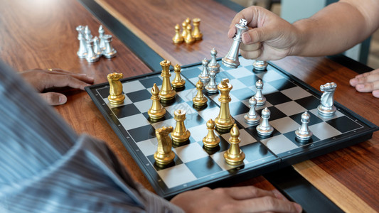 冲突商人在象棋盘游戏中将王牌人物与决胜者相提并论战略管理或领导才能成功概念领导者典当背景图片