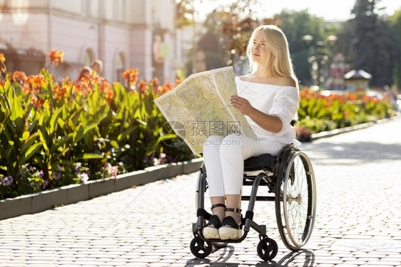 坐着孤独妇女看户外的轮椅郁闷图片