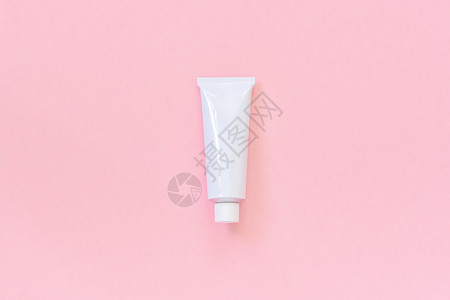 为了医疗的一个用于粉红色背景的奶油软膏牙或其他产品的空白化妆或医用锡管于您的设计模板或型复制空间顶视图一个用于粉红色奶油牙膏或其图片