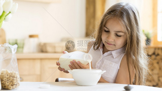 勺子混血前面看年轻女孩吃麦片早餐玻璃图片