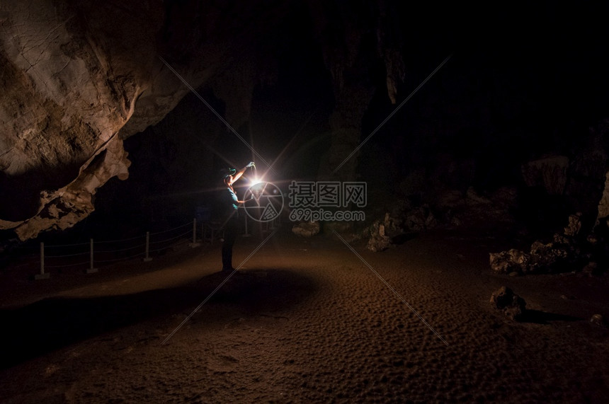 河钟乳石笋女探险家在洞穴内拿着灯笼ThamPaiMaeHongSonThamLod洞穴是泰国最惊人的洞穴之一图片